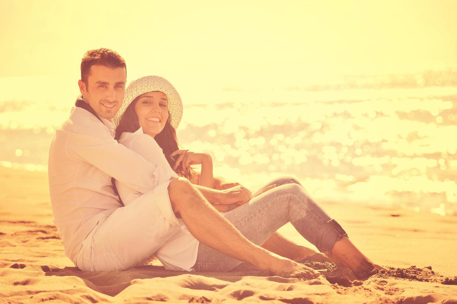 happy young couple have fun at beautiful beach photo