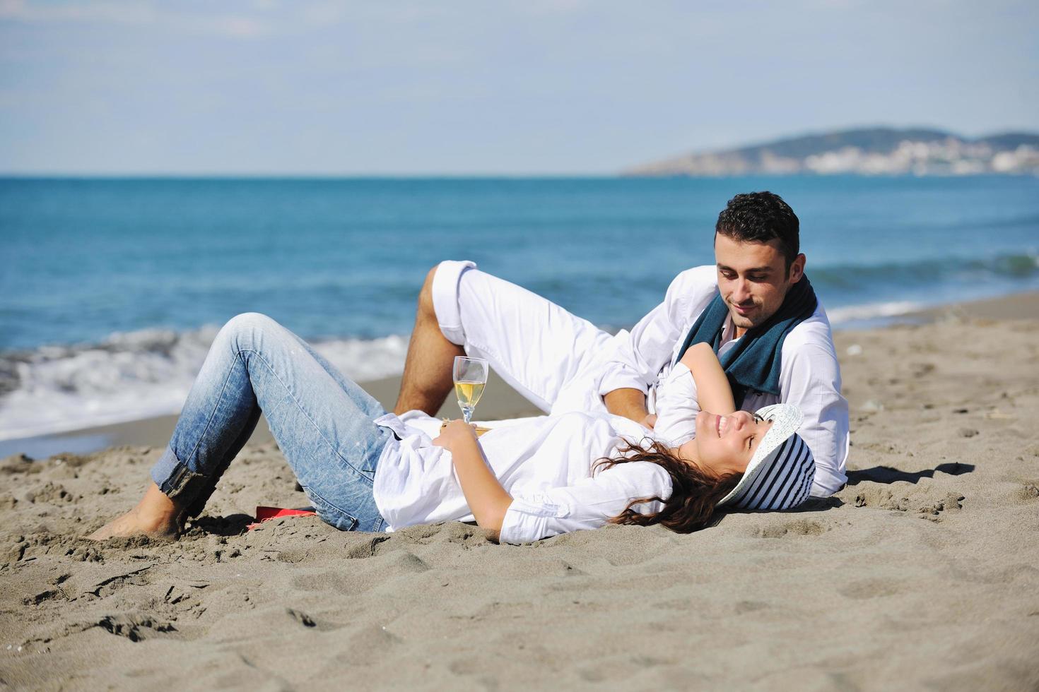 happy young couple have fun at beautiful beach photo