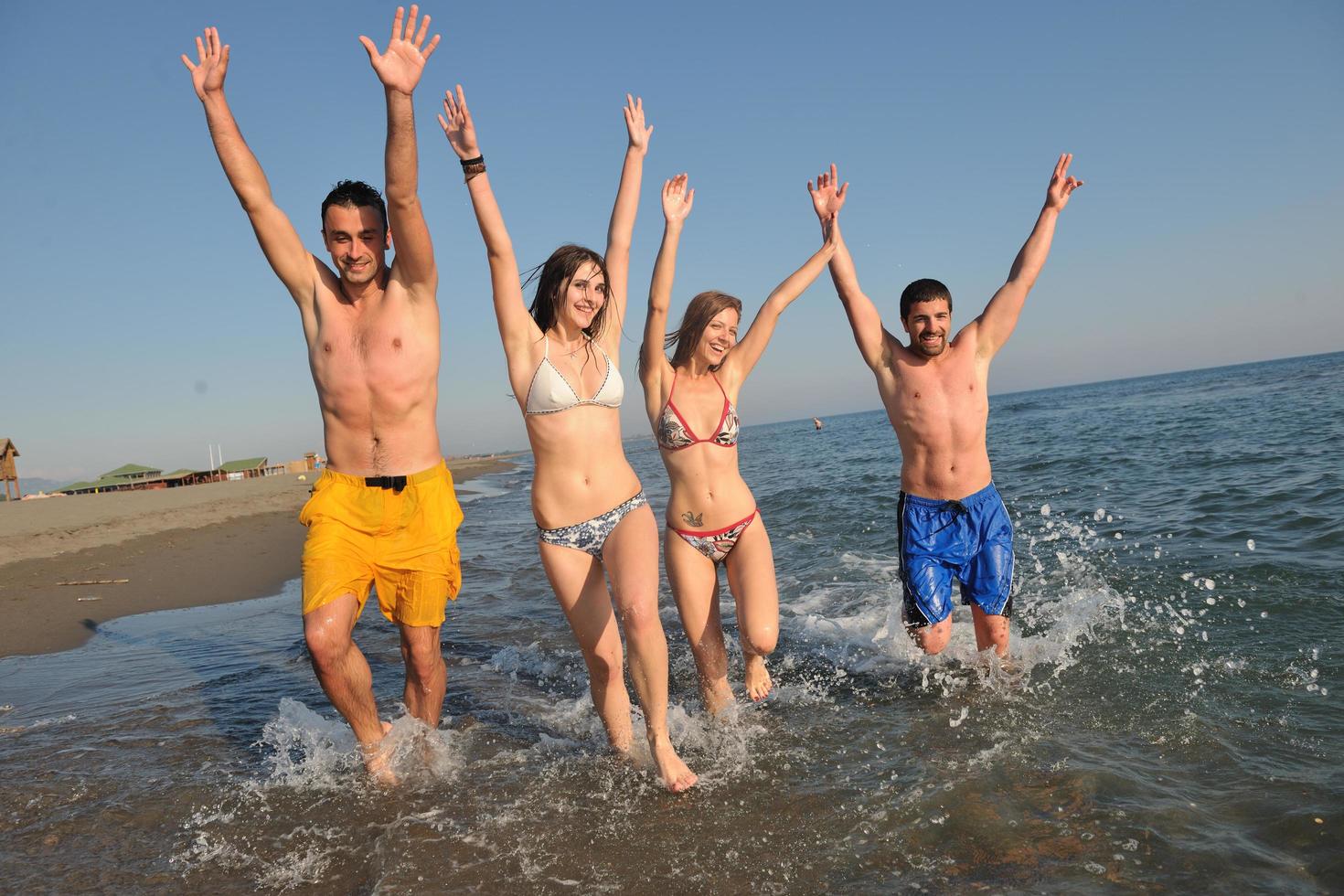 happy people group have fun and running on beach photo