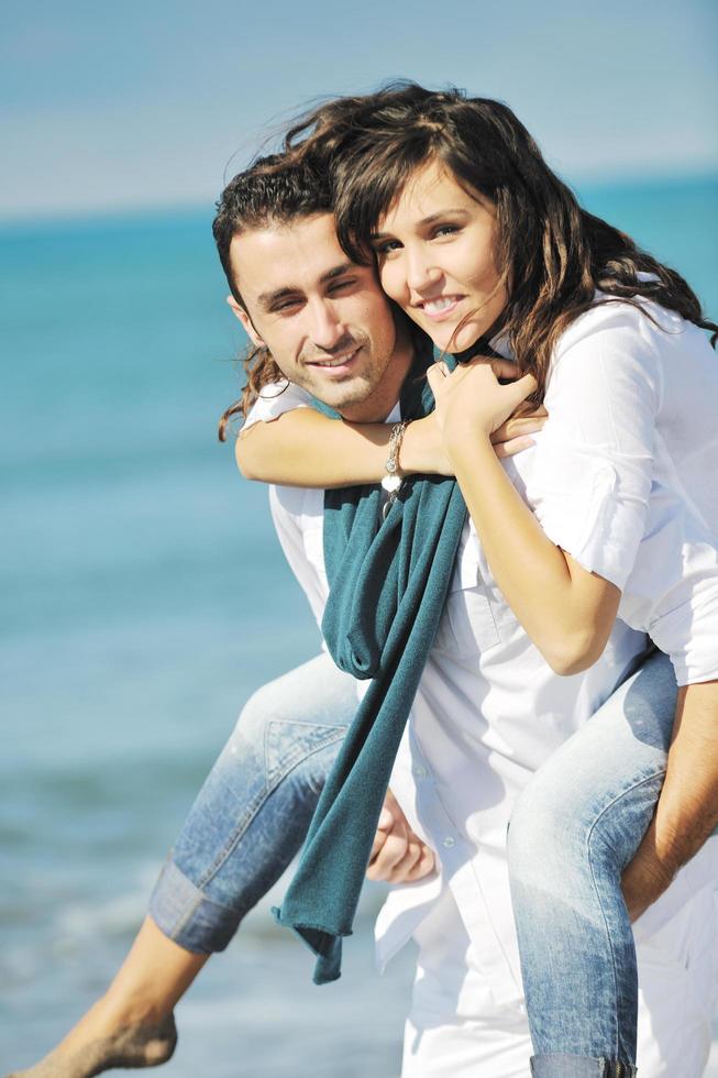 happy young couple have fun at beautiful beach photo
