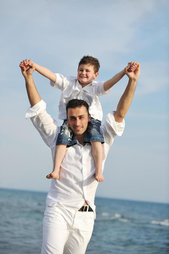 happy father and son have fun and enjoy time on beach photo