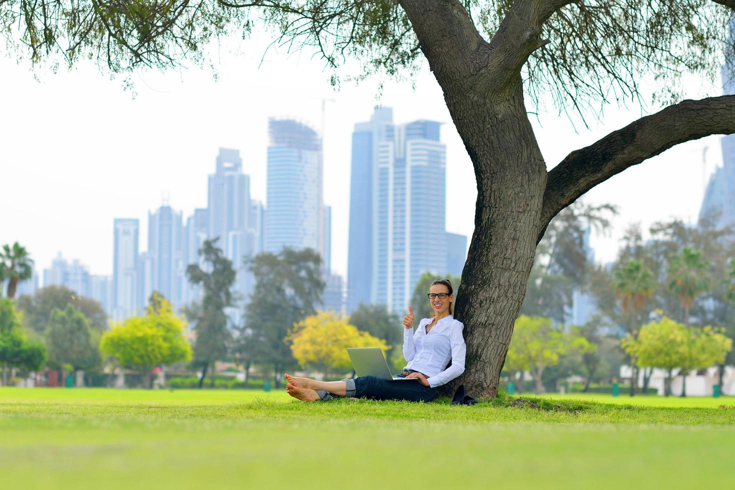 woman with laptop in park photo