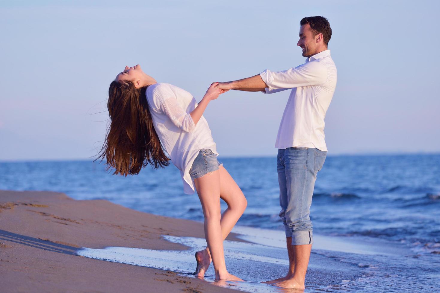 young couple  on beach have fun photo