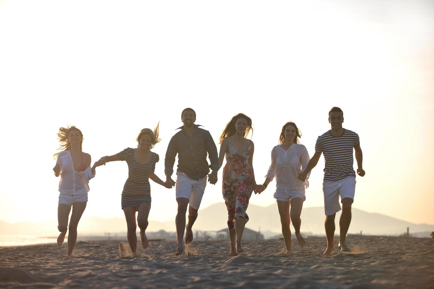 happy young  people group have fun on beach photo