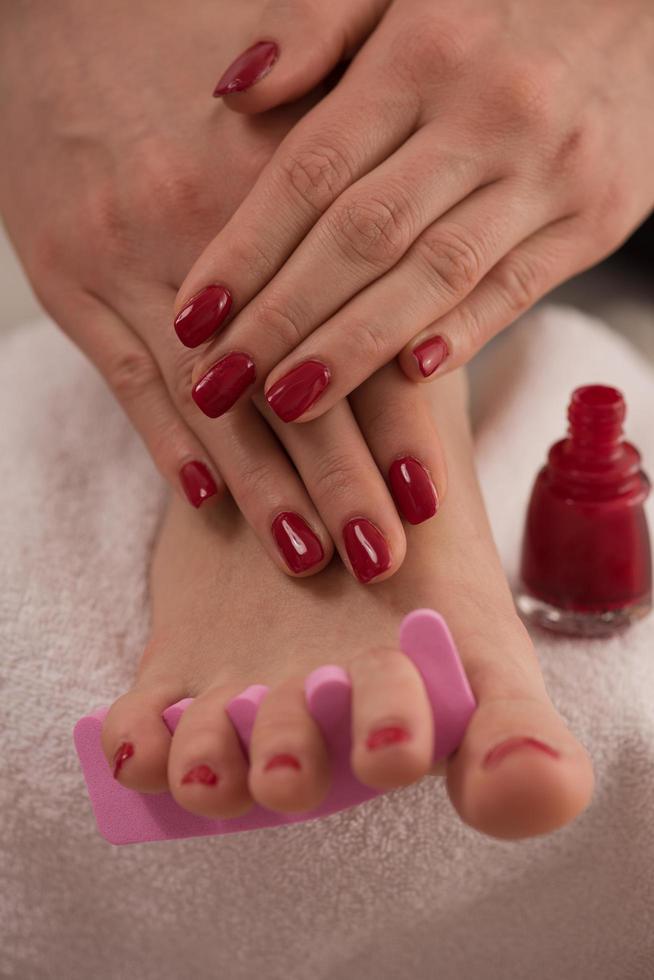 female feet and hands at spa salon photo