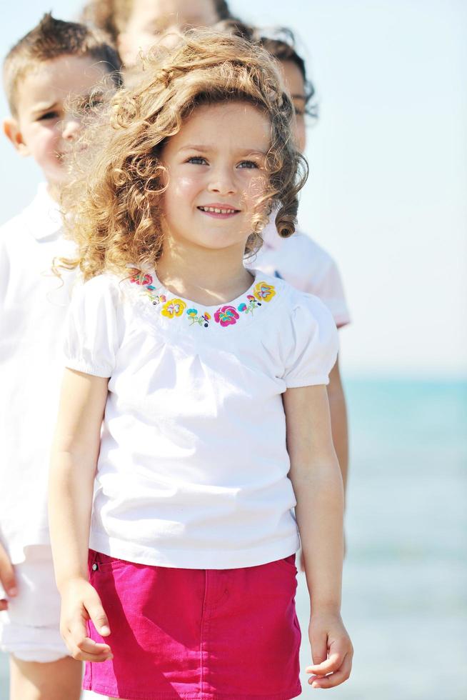 happy child group playing  on beach photo
