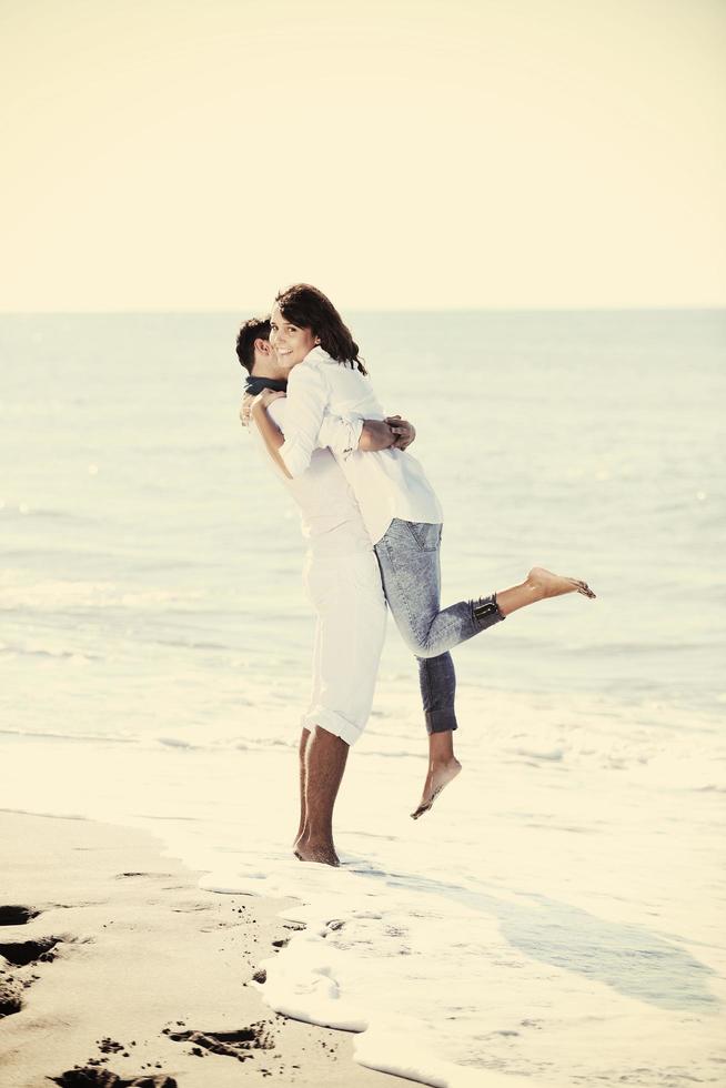 happy young couple have fun at beautiful beach photo