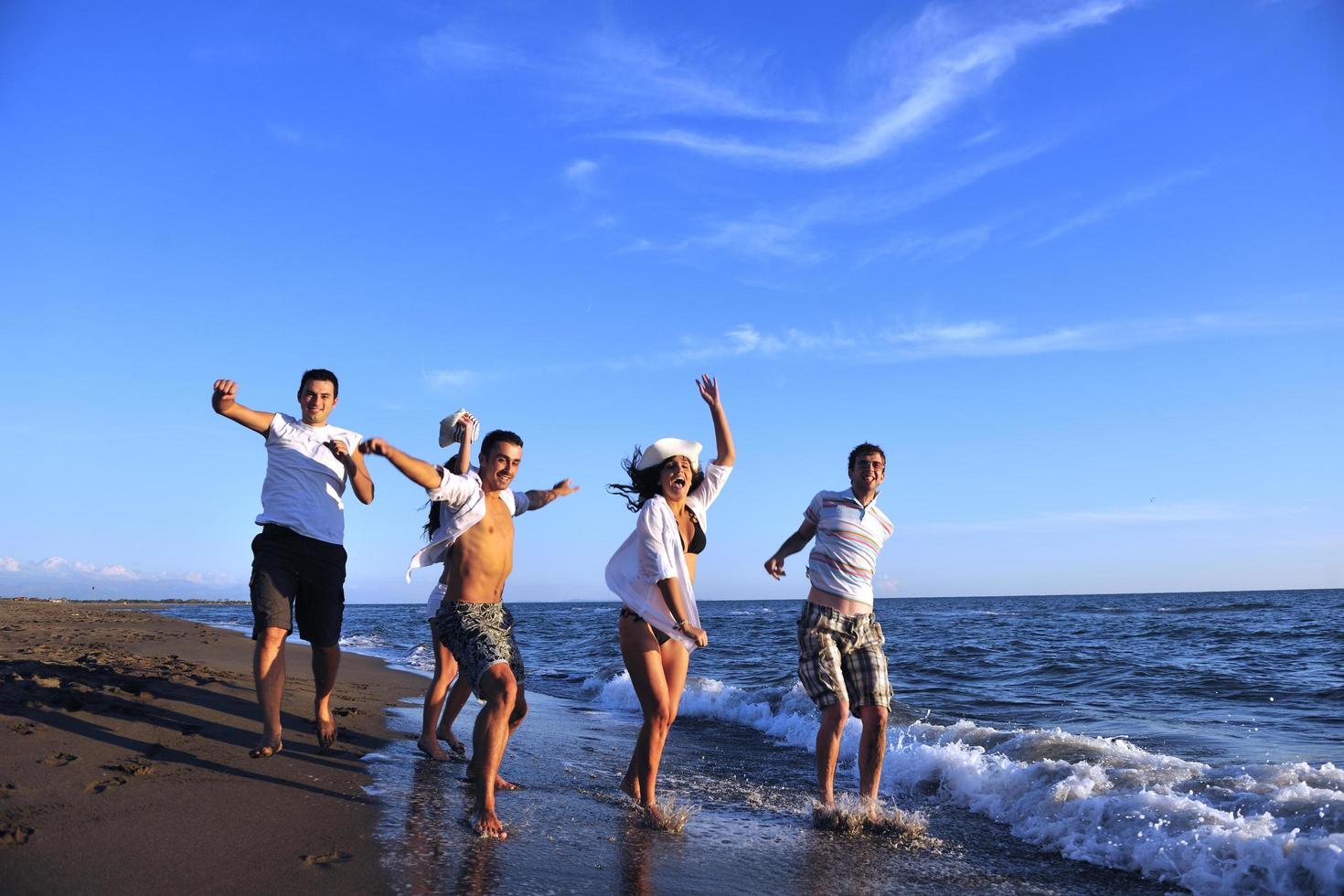 people group running on the beach photo