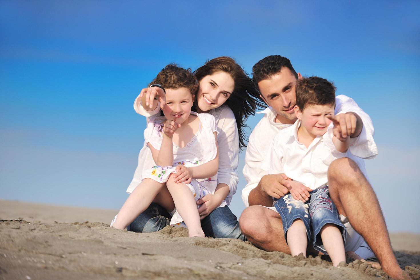 happy young family have fun on beach photo