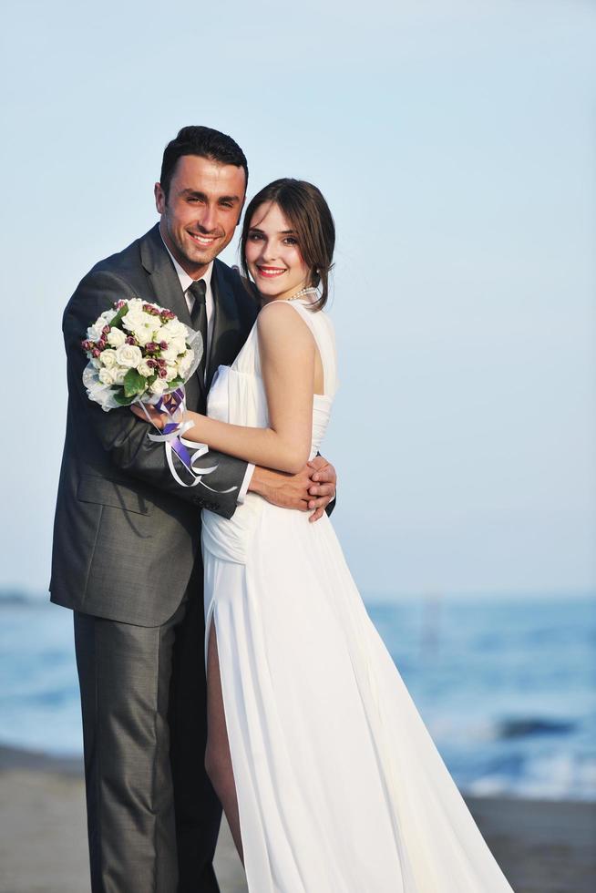 romantic beach wedding at sunset photo