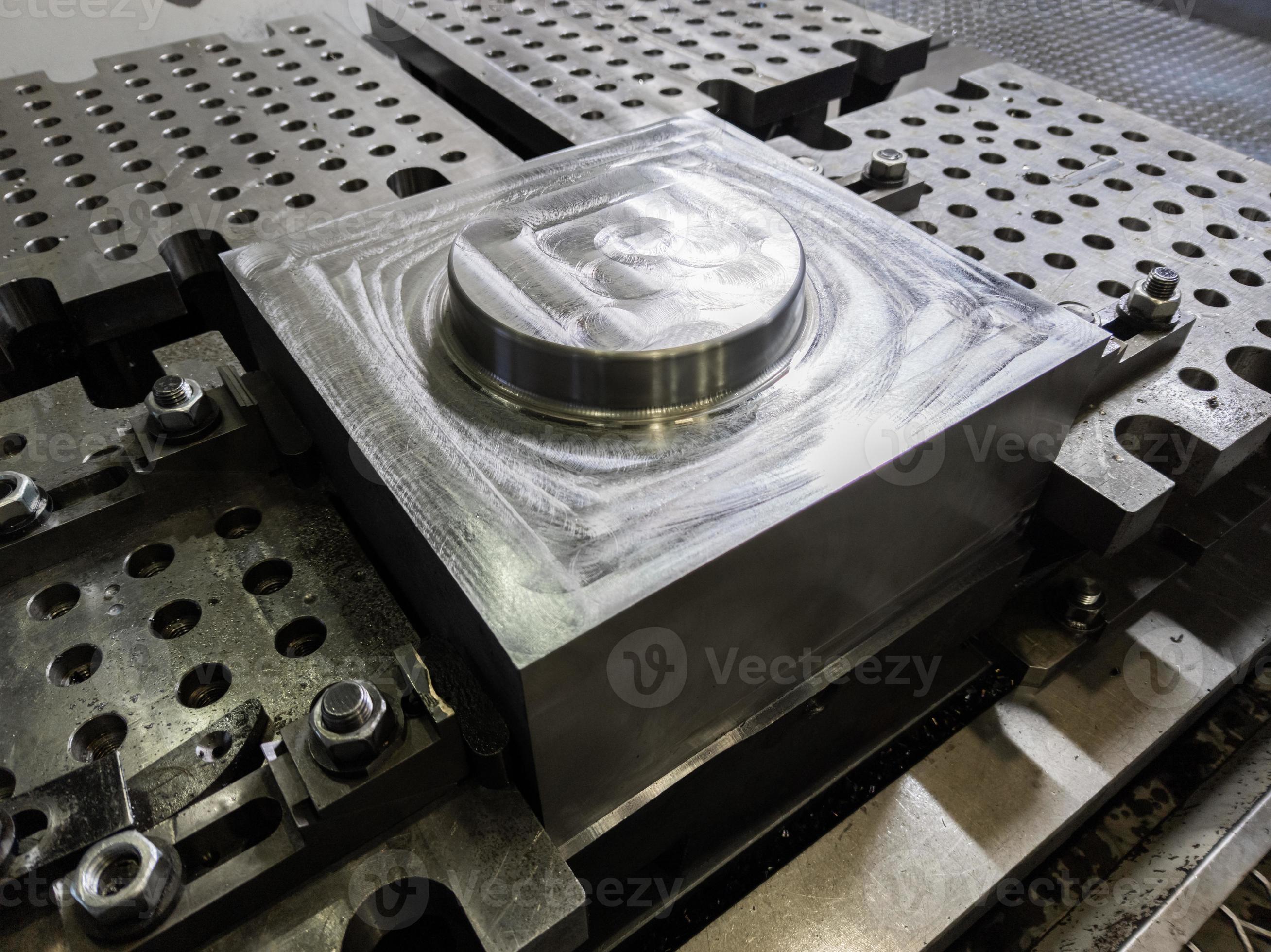 large steel workpiece after cnc surface milling on table of milling