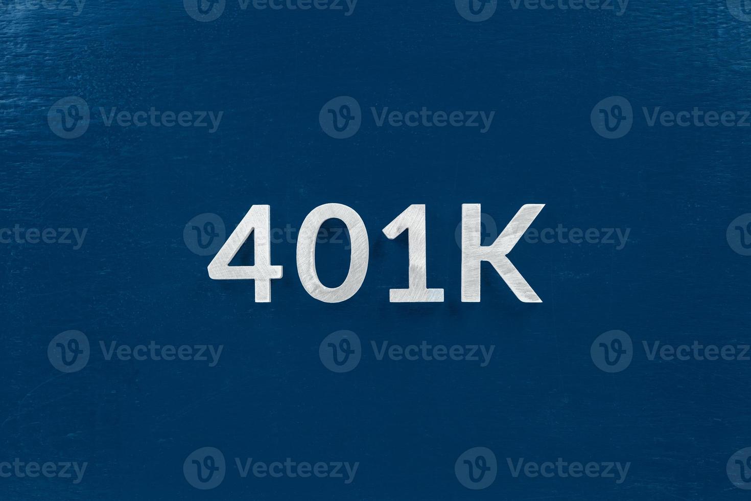 the word 401k laid with silver brushed metal letters on classic blue surface - centered in flat lay directly above perspective photo