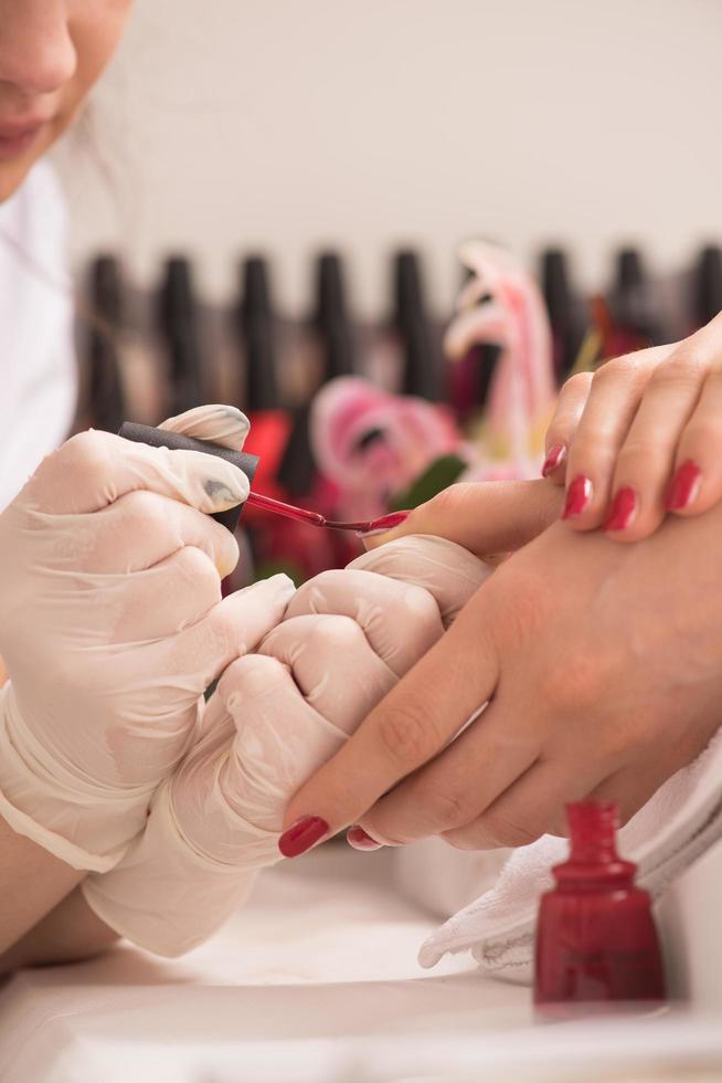 manos de mujer recibiendo una manicura foto