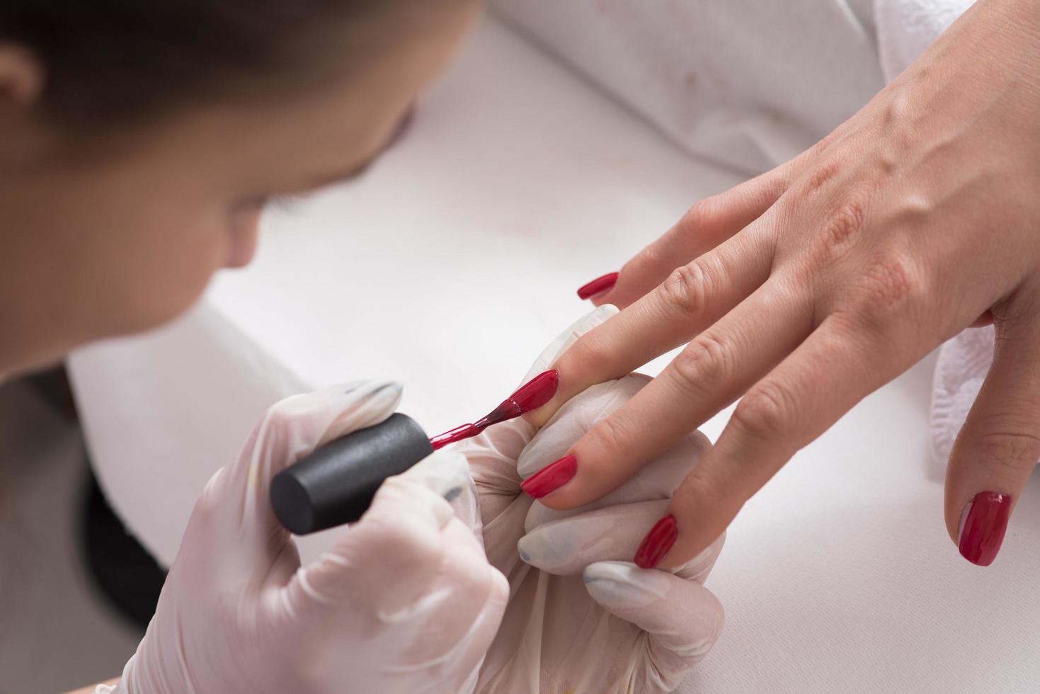 manos de mujer recibiendo una manicura foto