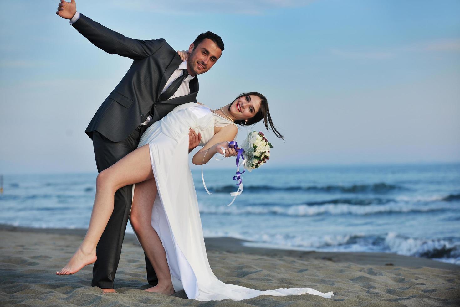 romantic beach wedding at sunset photo