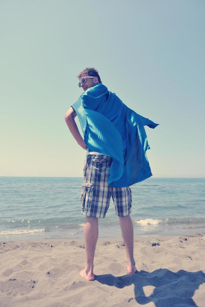 funny superhero standing on beach photo