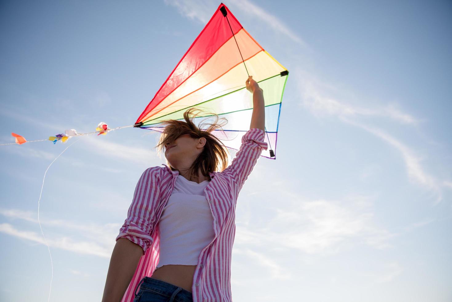 Young Woman with kite at beach on autumn day photo