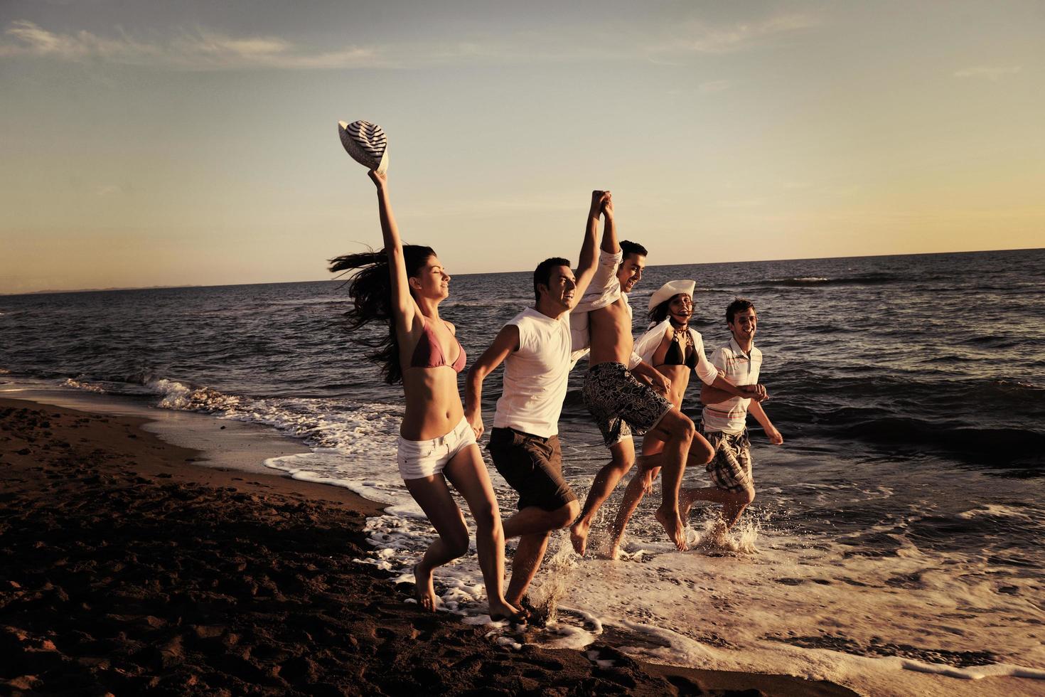 people group running on the beach photo