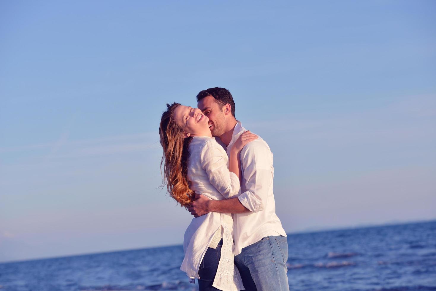 young couple  on beach have fun photo