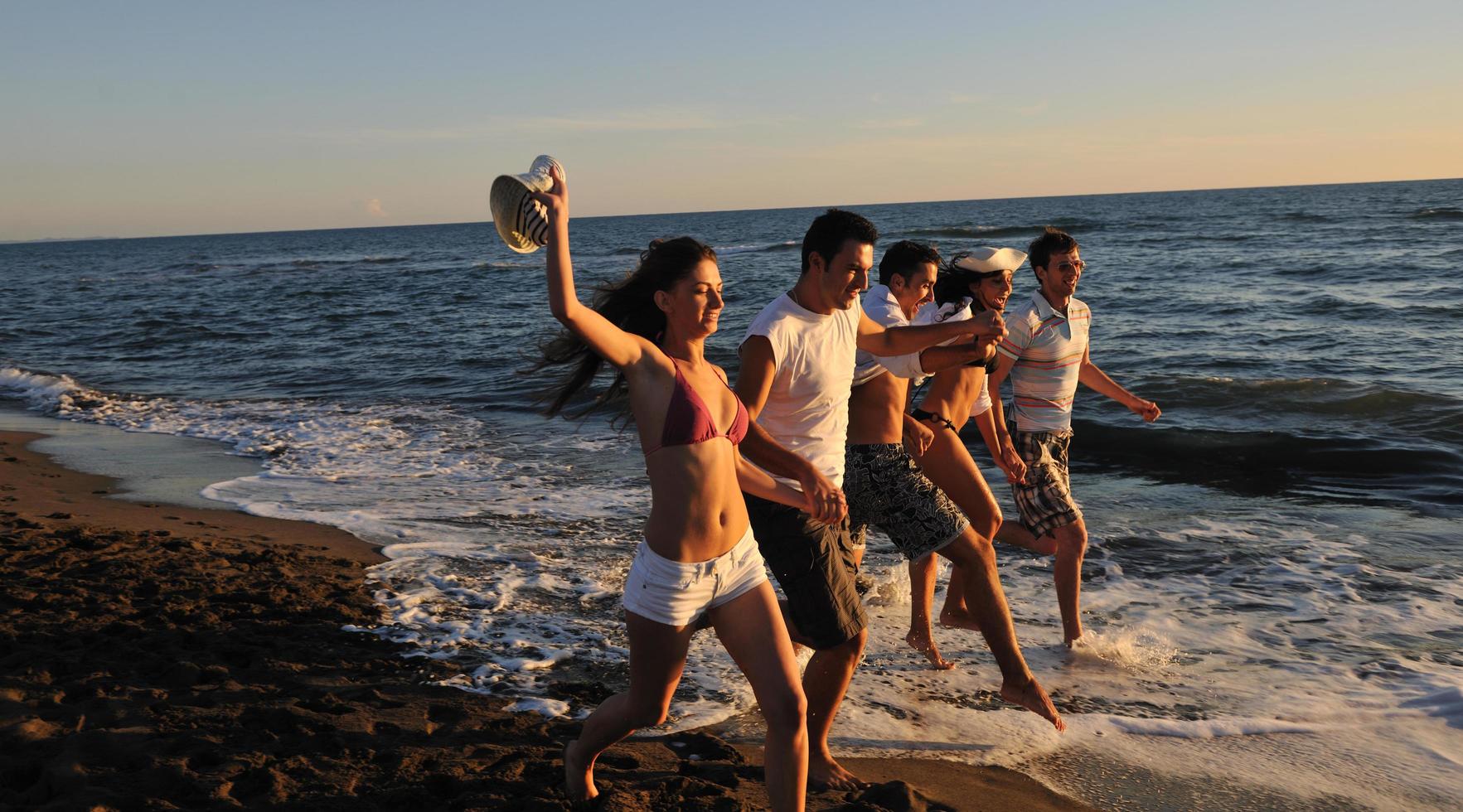people group running on the beach photo
