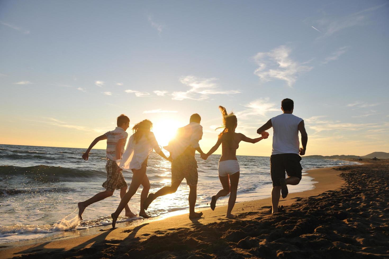 people group running on the beach photo