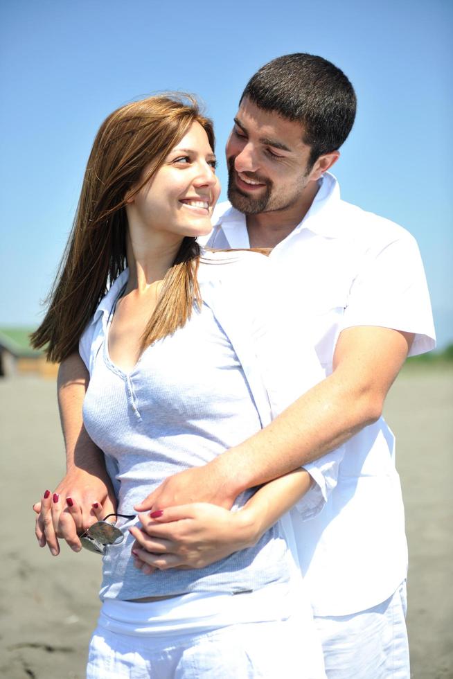 happy young couple have fun on beach photo