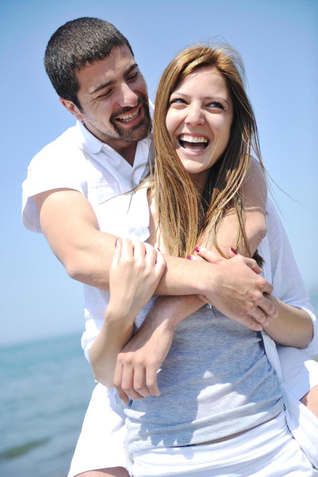 happy young couple have fun on beach photo