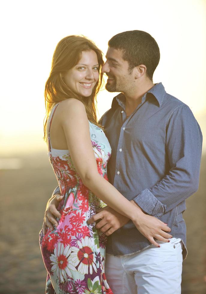 happy young couple have romantic time on beach photo