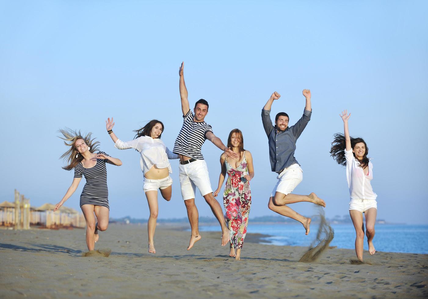 happy young  people group have fun on beach photo