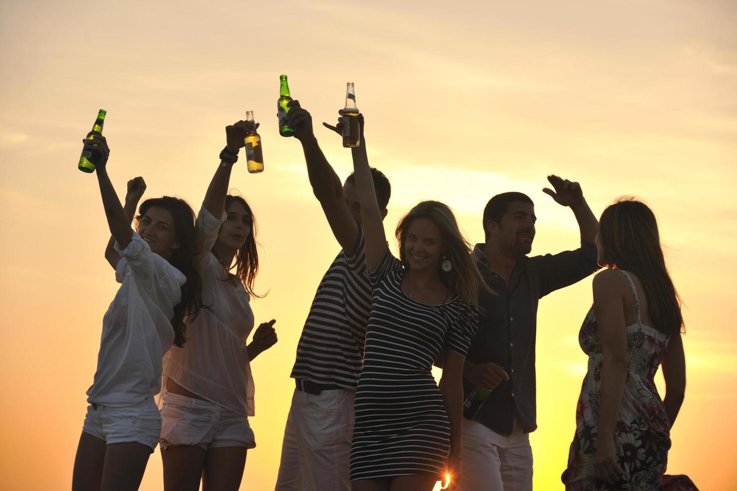 Group of young people enjoy summer  party at the beach photo