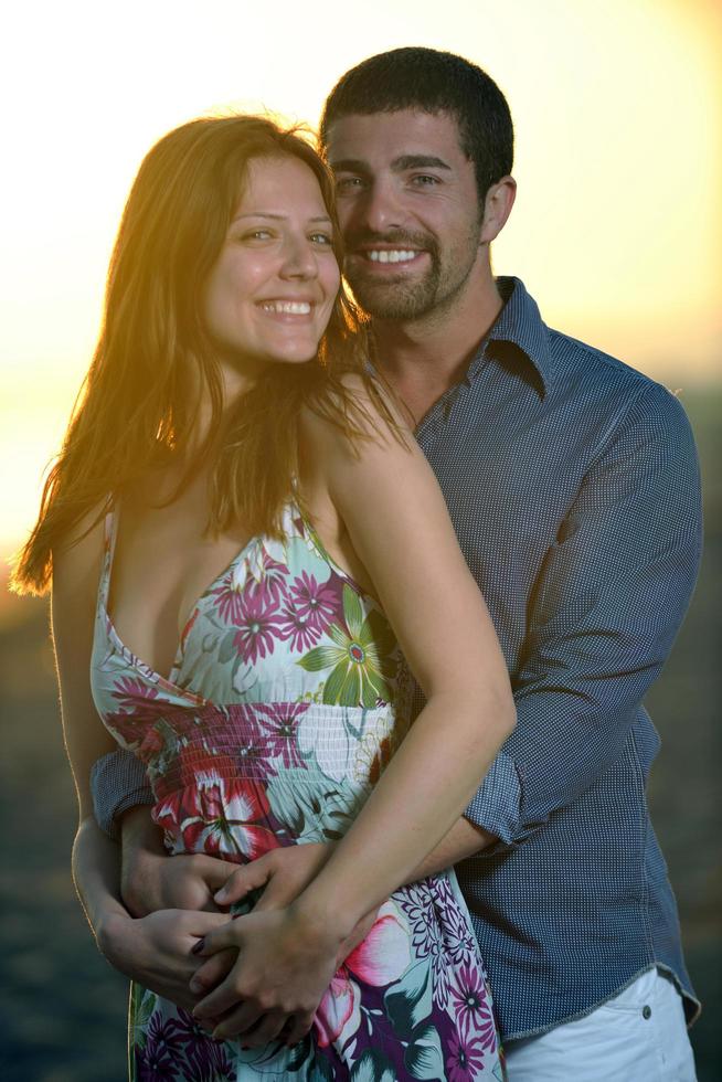 happy young couple have fun on beach photo