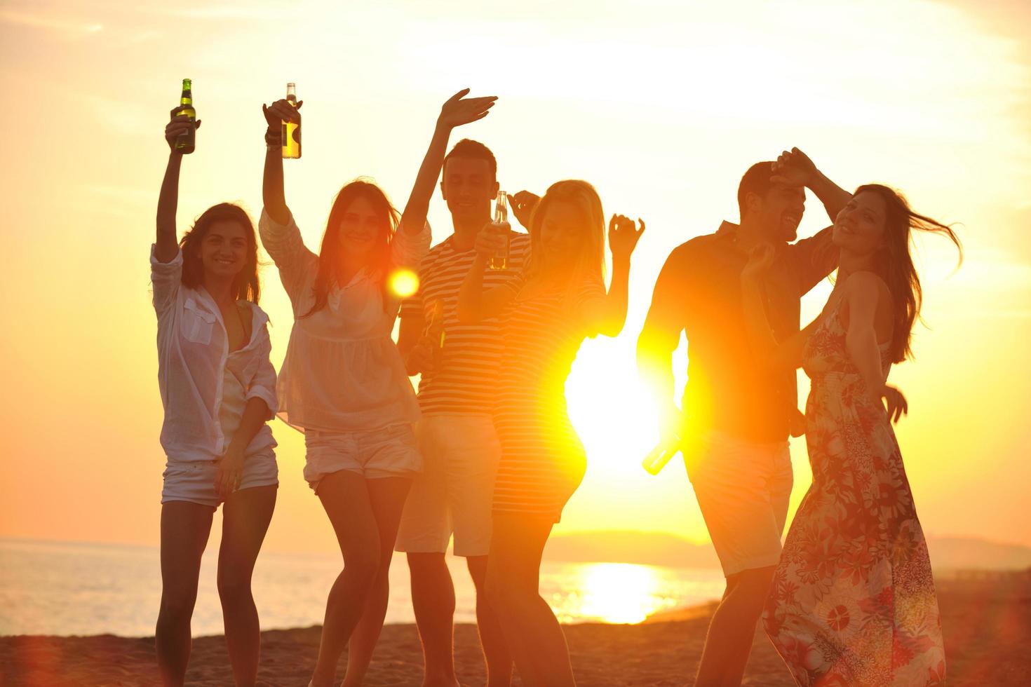 Group of young people enjoy summer  party at the beach photo