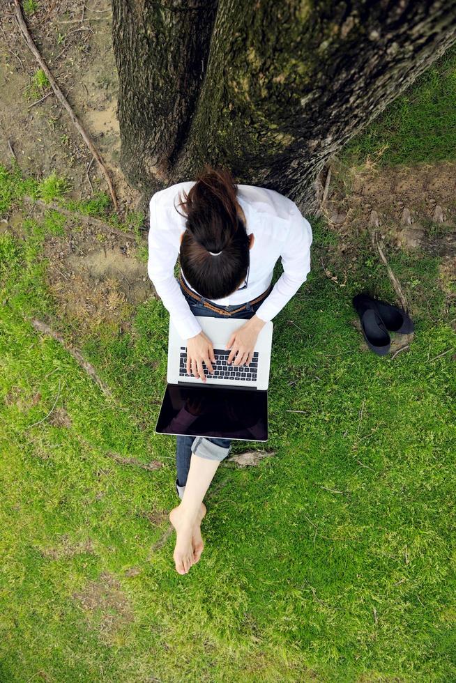 woman with laptop in park photo