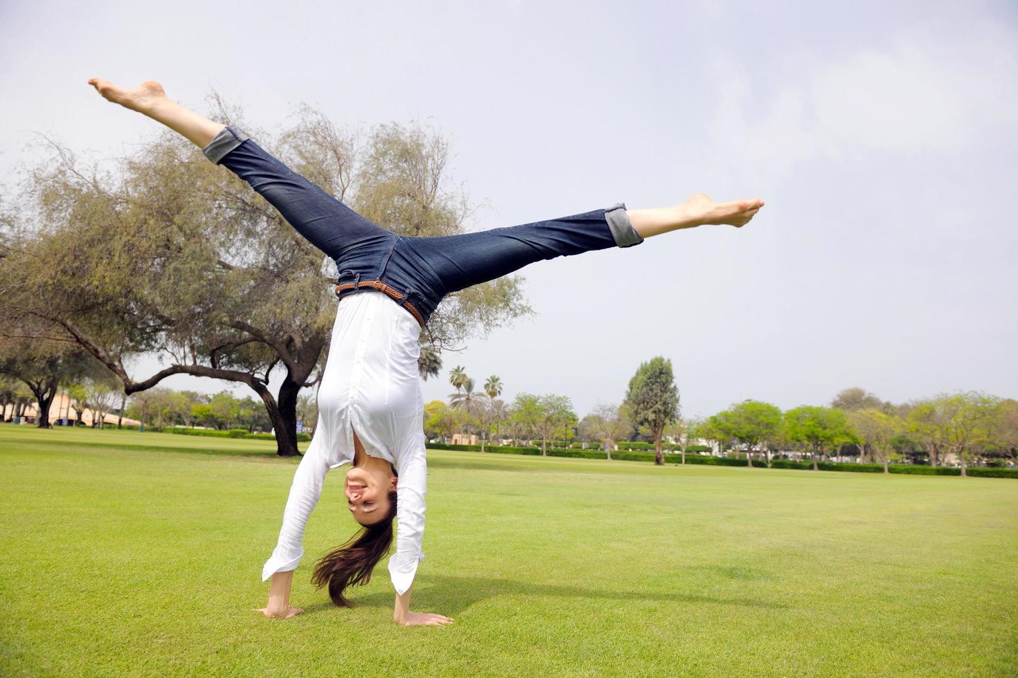 young woman jumping in park photo