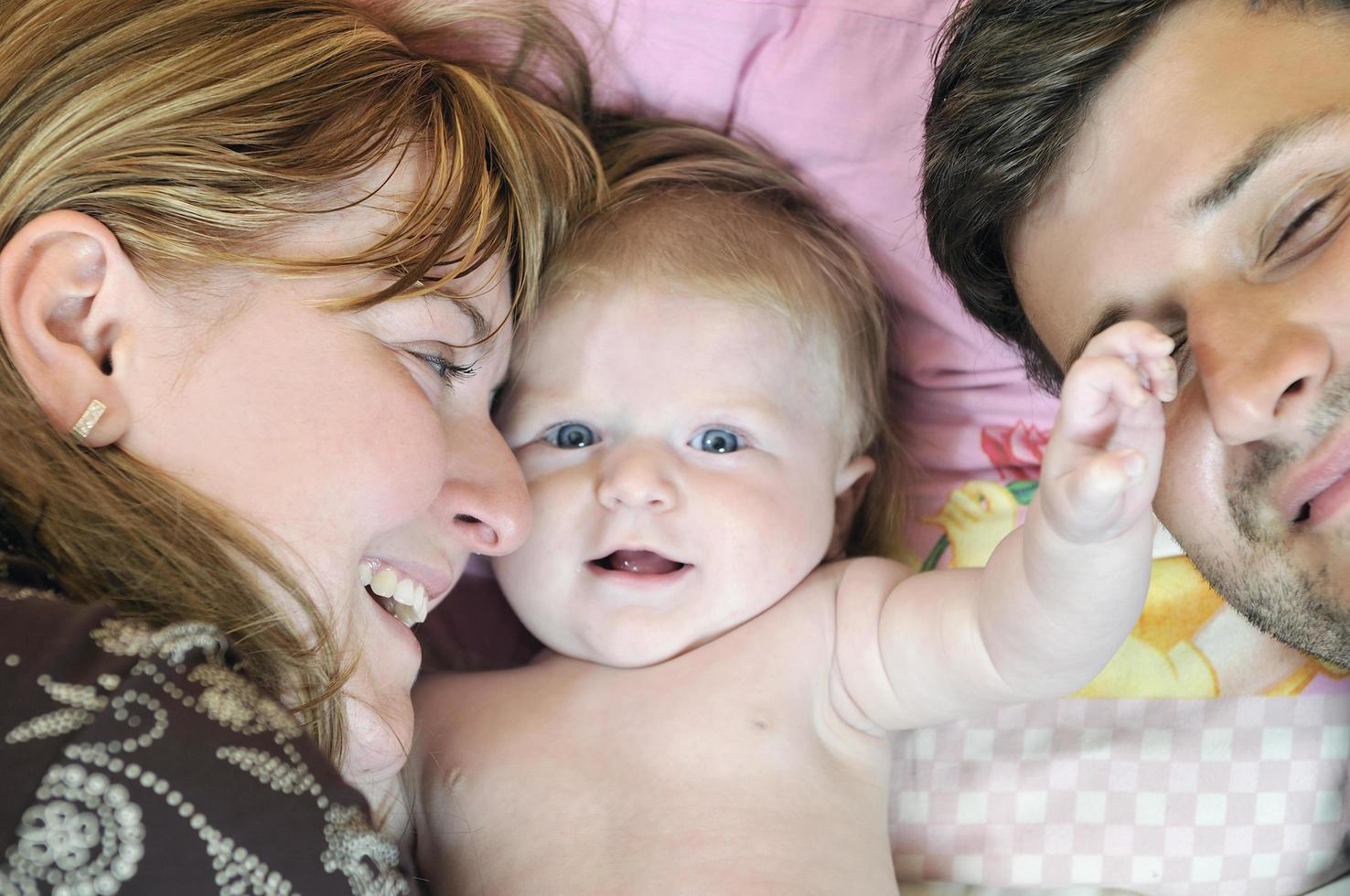 portrait of young family with  cute little babby photo