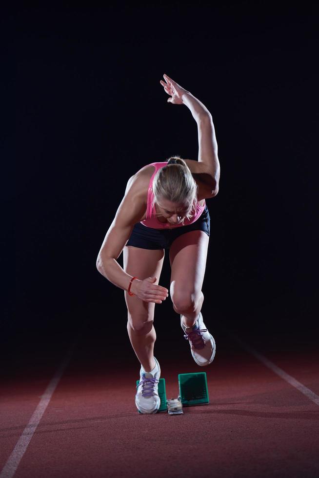 pixelated design of woman  sprinter leaving starting blocks photo