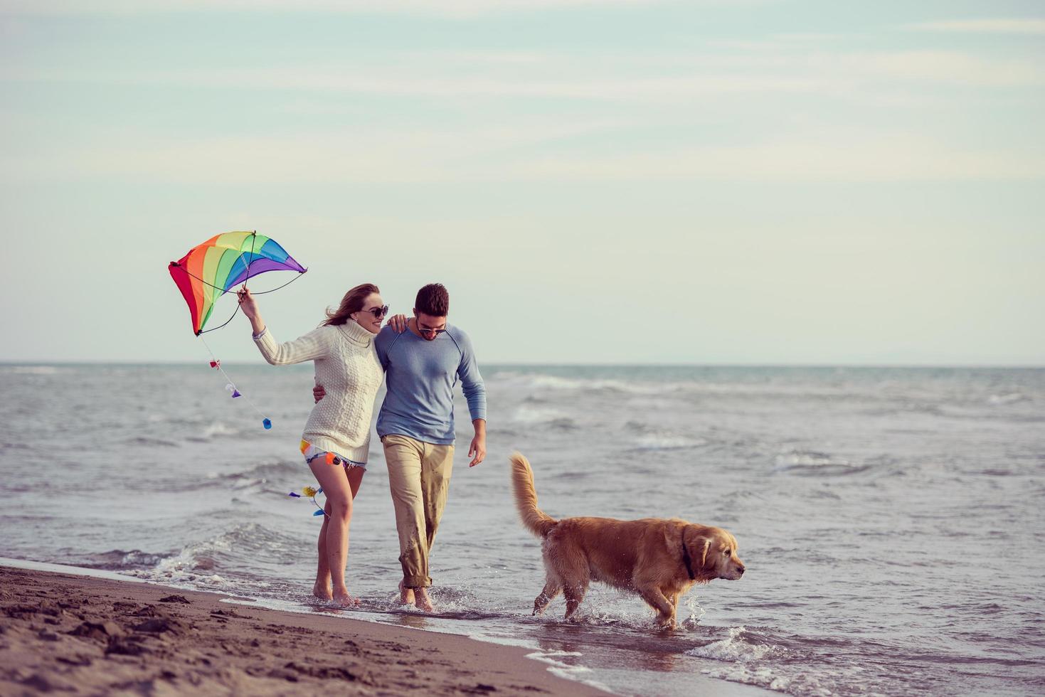 happy couple enjoying time together at beach photo