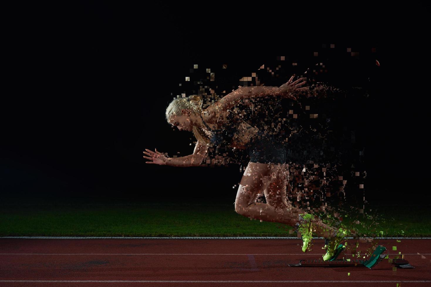 woman  sprinter leaving starting blocks photo