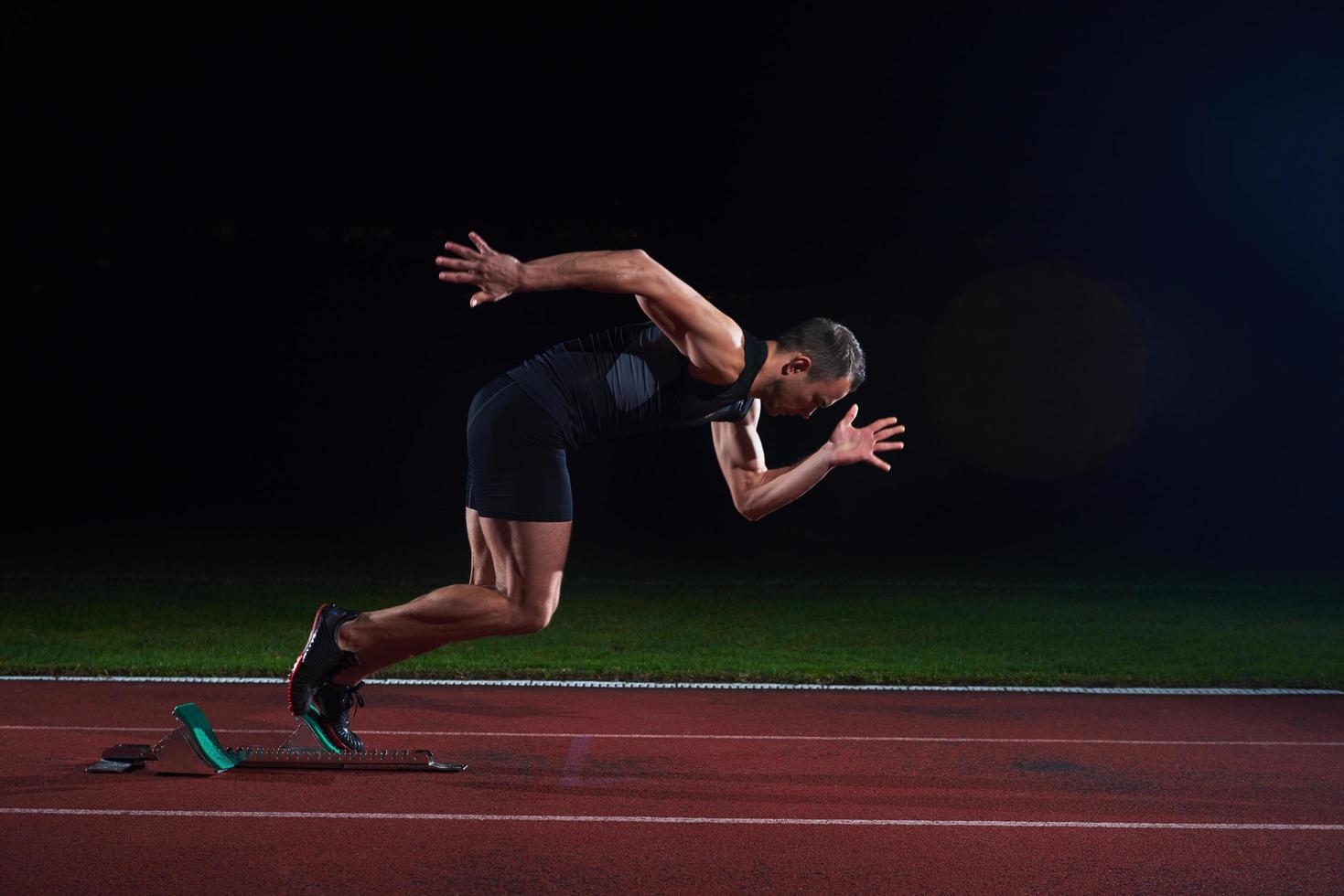 Sprinter leaving starting blocks photo