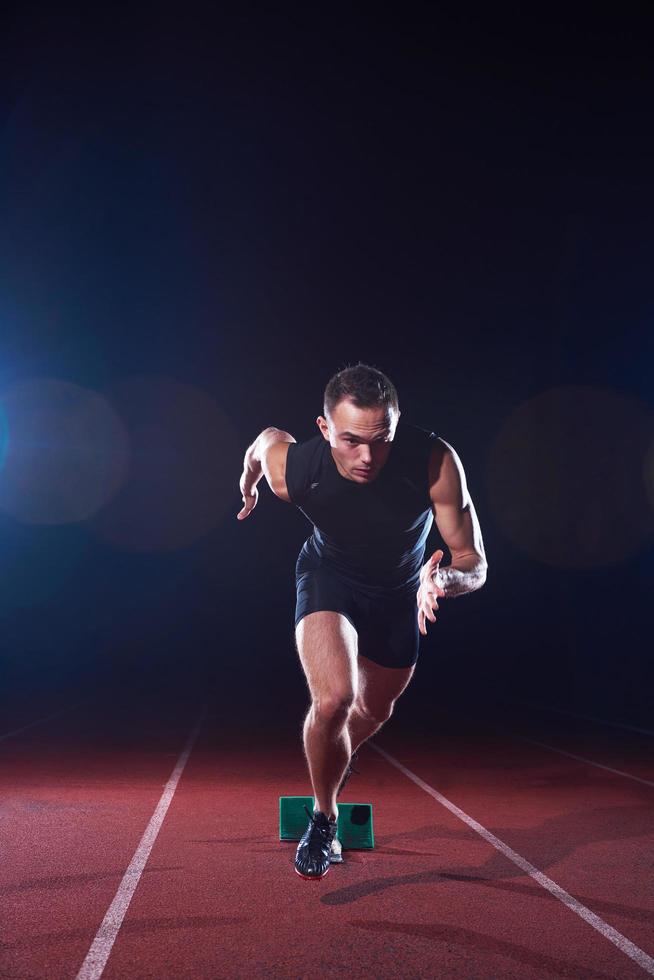 Sprinter leaving starting blocks photo