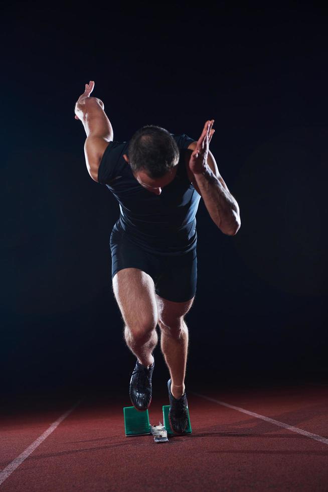 Sprinter leaving starting blocks photo
