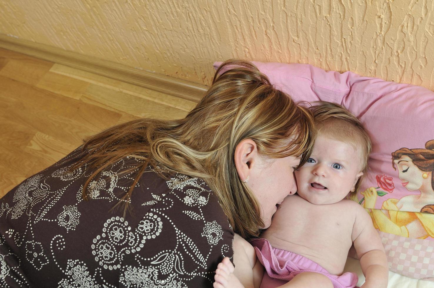 beautiful blonde young mother and cute baby photo