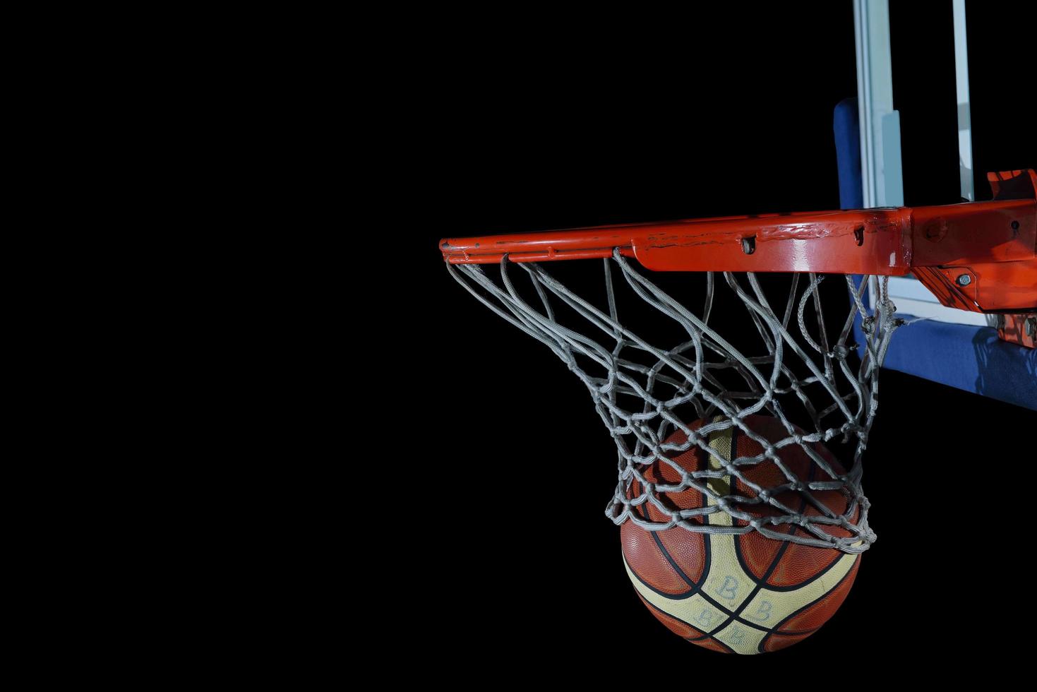 basketball ball and net on black background photo