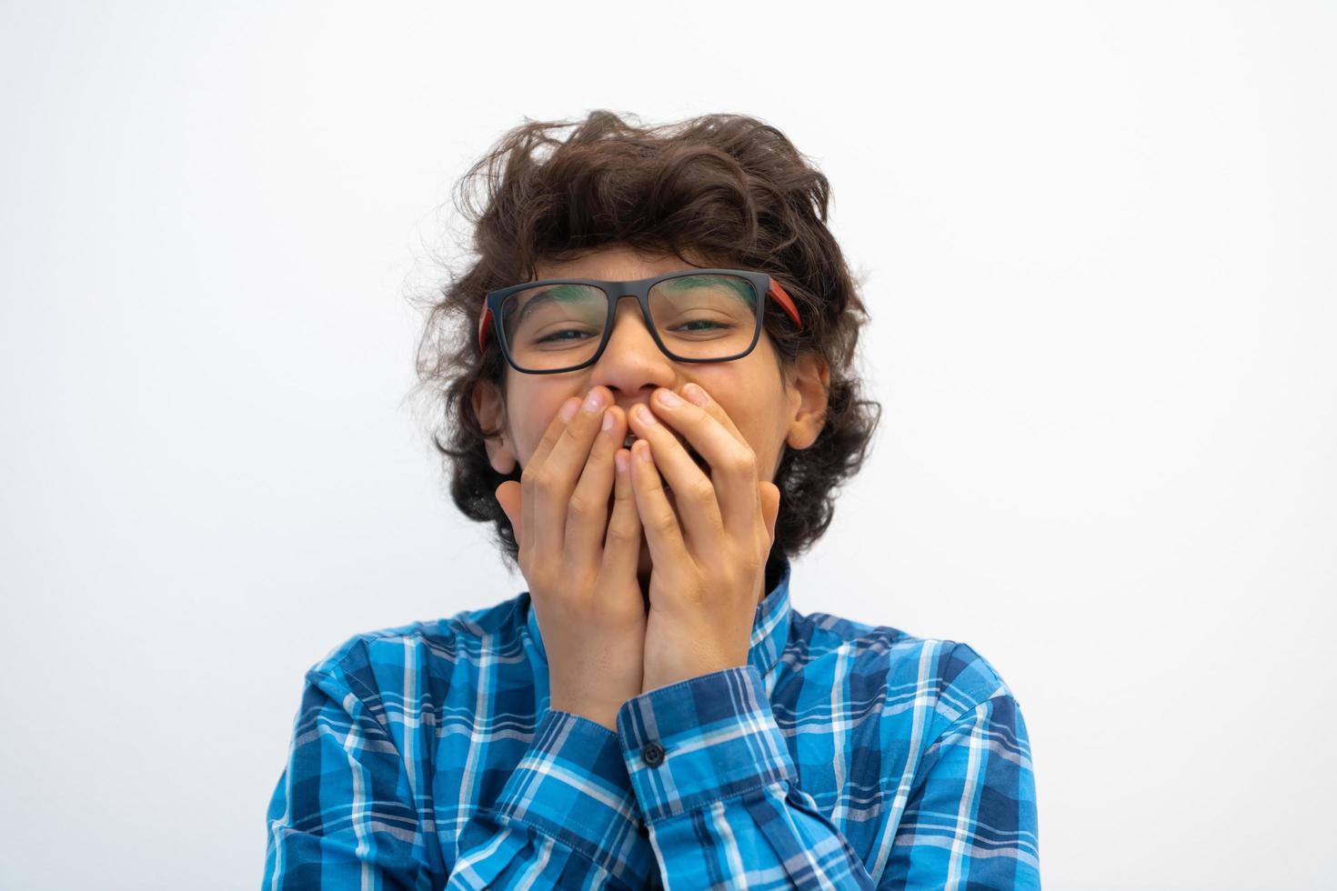 portrait of smart looking arab teenager with glasses wearing a hat in casual school look isolated on white copy space photo