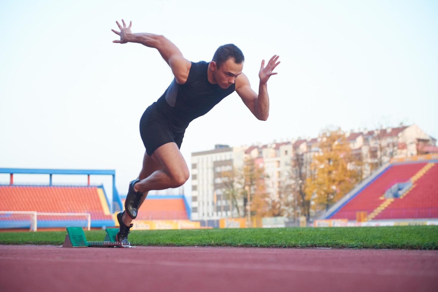 pixelated design of woman  sprinter leaving starting blocks photo