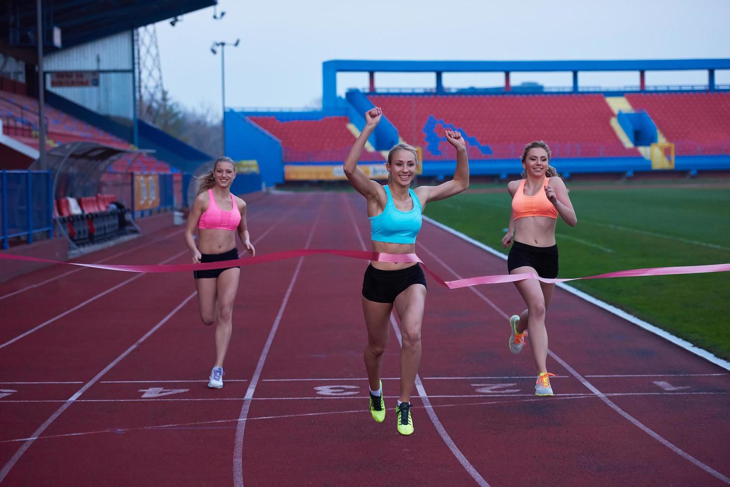 Female Runners Finishing Race Together photo