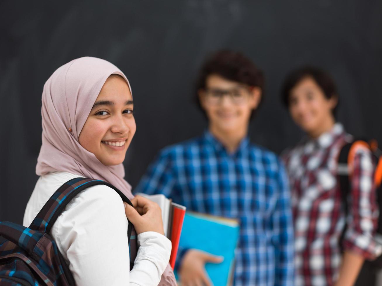 Arabic teenagers team, students group working together on laptop and tablet computer online classroom education concept. Selective focus photo