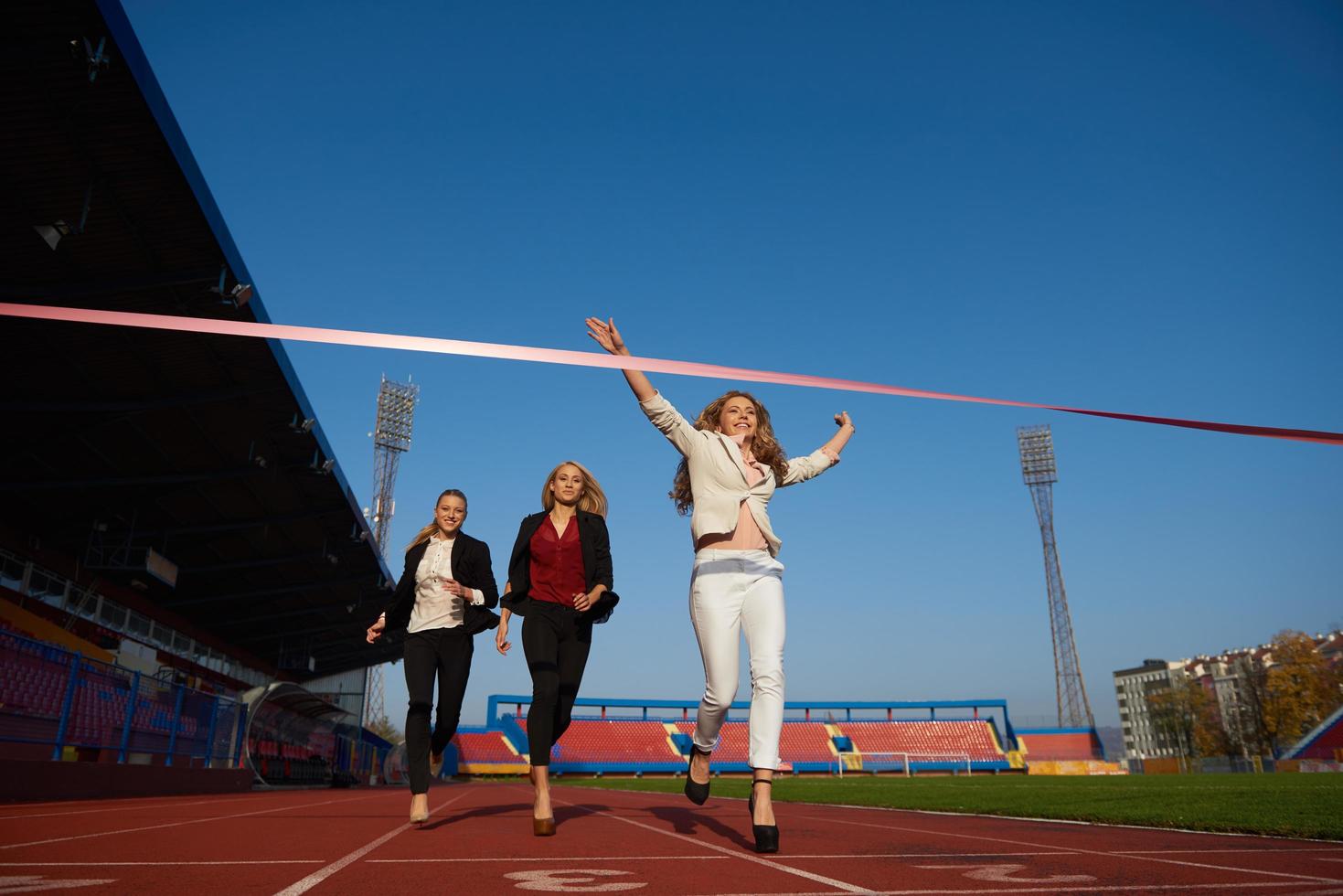 business people running on racing track photo
