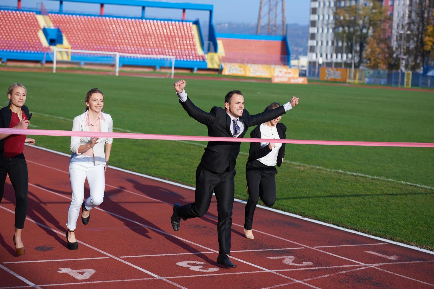 business people running on racing track photo