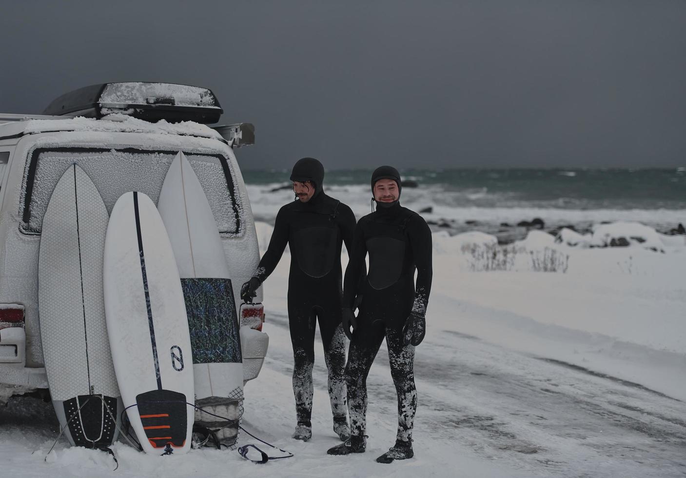 Arctic surfers in wetsuit after surfing by minivan photo